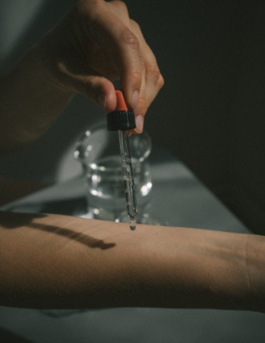 Applying oud oil to wrist